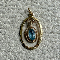 Victorian era Oval Pendant with Pale Blue Faceted Stone set in 18k Gold, Signed